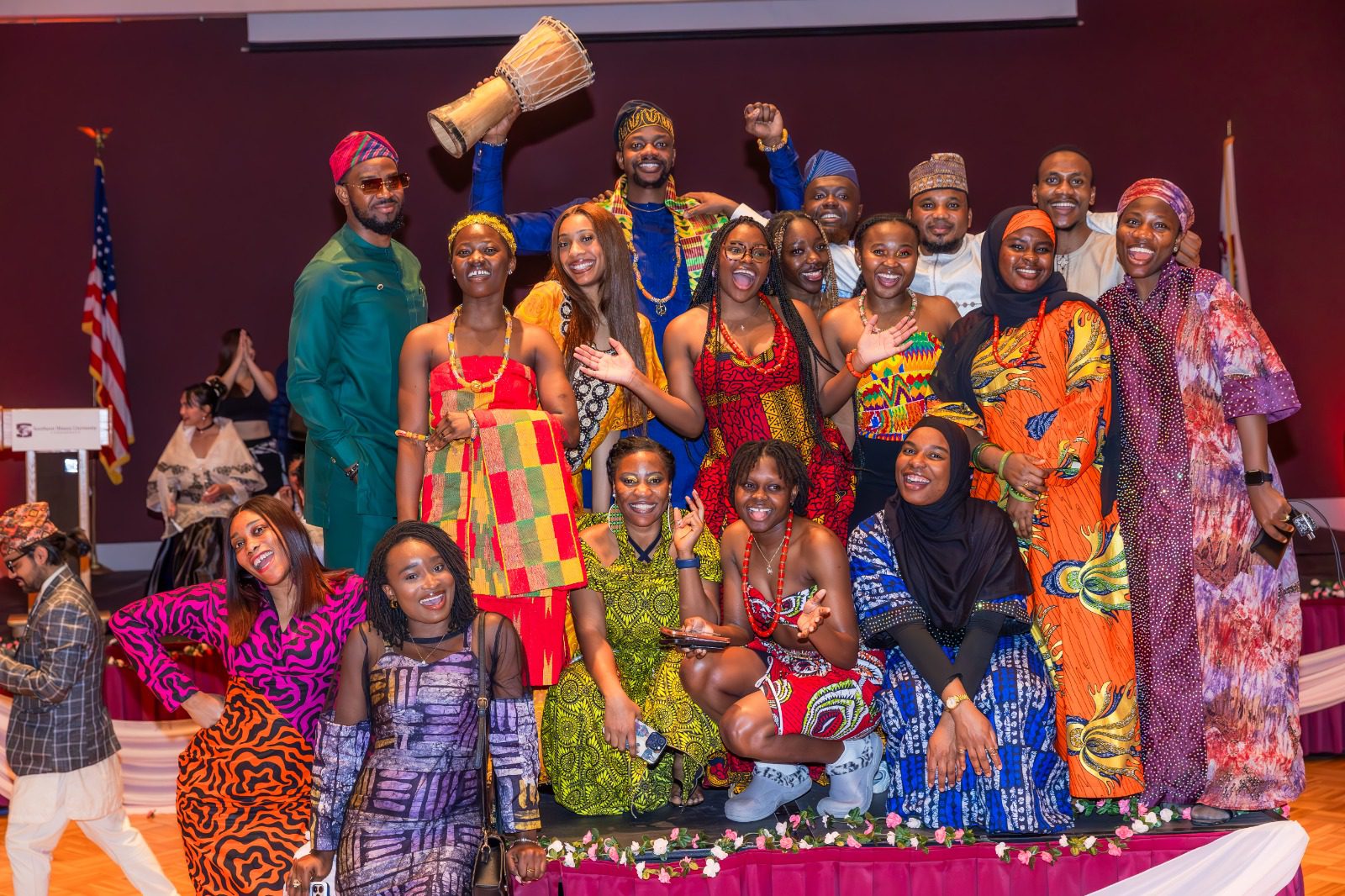Members of the African Student Union pose for a group photo on stage during International Cultural Night, wearing traditional clothing representing their cultural heritage.