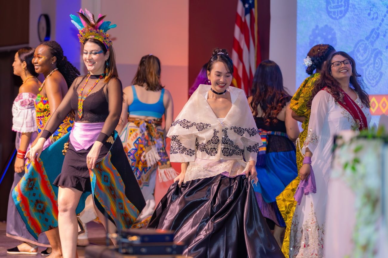 Multicultural Empowered Women Student Association (MEWSA) members showcase traditional clothing from their countries during a cultural dance presentation at SIU Carbondale's International Cultural Night 2026.